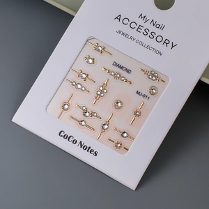 Macro shot of gold-plated K9 nail crystals on a white display card model MJ-011