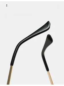 Detail view of ergonomic curved glasses legs with black resin and gold metal finish