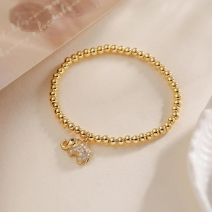 Detail of 18K gold-plated beaded bracelet with micro-pave zircon elephant charm