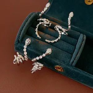 Silver snake earrings with sparkling zircons displayed in a luxury velvet jewelry box