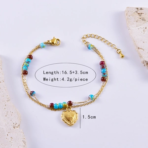Detail view of double-layer beaded bracelet with embossed heart pendant and measurements