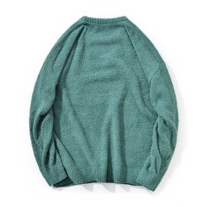 Detailed texture of dark green chenille knit fabric on a men's round neck sweater