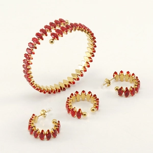 Detail of 18K gold plated jewelry set with red marquise gemstones and matching bracelet