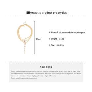 Detail view showing multi-layer gold chain necklace with pearls and size measurements