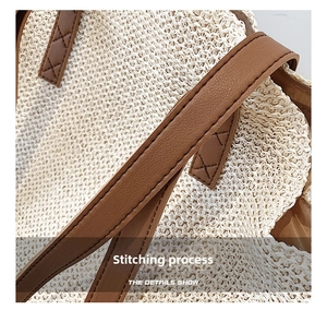 Detail showing the meticulous stitching craft on straw tote bag with brown leather handle