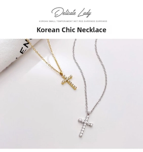 Detailed close-up of gold and silver cross necklaces with zircon inlays and O-chains