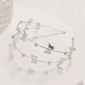 Detail of silver double-layered headband featuring butterfly and crystal embellishments