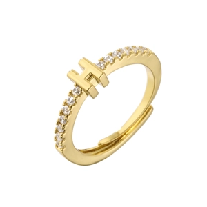 Detail of adjustable gold ring with micro-pave crystals and letter H centerpiece