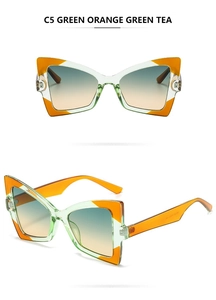 Detail of C5 butterfly sunglasses featuring green orange frames and tea gradient lenses