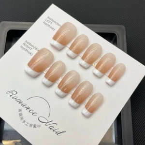 Handmade ballerina French gradient press-on nails with 10 pieces on a display board