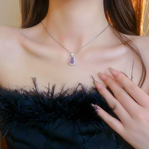 Close-up of elegant purple glass gourd pendant necklace with sparkling zircon accents