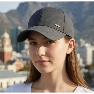 Detail of dark gray baseball cap featuring a golden metal 'FASHION' side plate accent