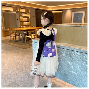 Detail of a purple Halloween themed crossbody bag with ghost and pumpkin patterns