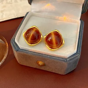 Elegant gold earrings featuring brown cat-eye stones in a vintage minimalist design