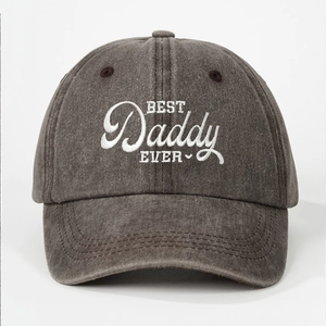 Macro shot of white BEST DADDY EVER embroidery on washed dark gray cotton baseball cap