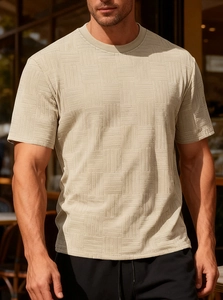 Macro detail of men's khaki slim fit T-shirt showing 3D geometric knit texture and fabric