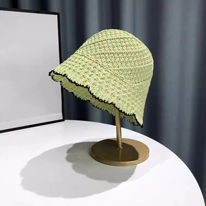 Detail of lime green crochet bucket hat with black wavy edge and breathable mesh texture