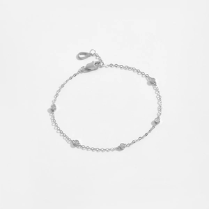 Minimalist S925 sterling silver bracelet with sparkling round diamond charms on white background