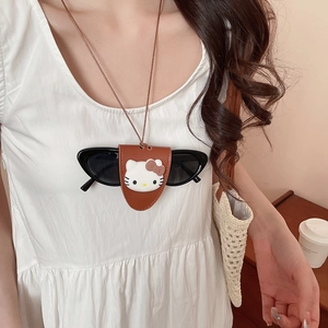 Macro detail of brown leather Hello Kitty glasses holder necklace with cat eye sunglasses