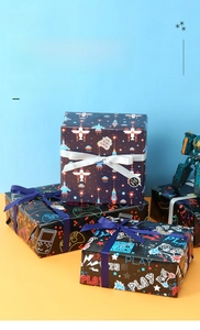 Deep blue game console wrapping paper with pixel rocket and gaming controller patterns