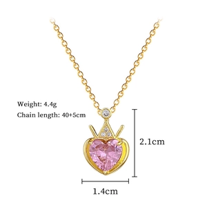 Detail view of gold crown heart necklace with pink gemstone and size measurements