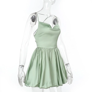 Detail of light green satin mini dress showing silky fabric texture and tiered skirt layers