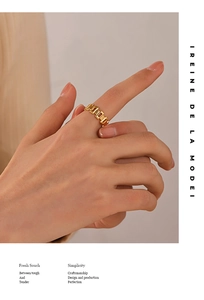 Detail of 18K gold-plated chain link ring showing polished industrial style on a finger