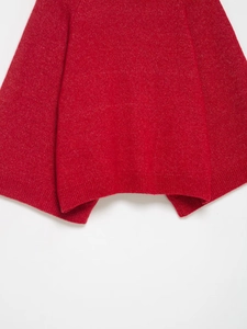 Detail shot of the ribbed hem and red knitted fabric texture of the women sweater