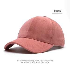 Close-up of soft pink faux suede baseball cap showing fine fabric texture and classic seams