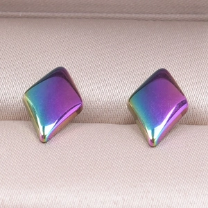 Macro detail of geometric rhombus earrings with iridescent rainbow gradient plating