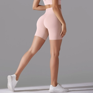 Detailed back view of pink high-waisted seamless yoga shorts showing butt lifting effect