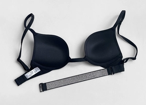 Detailed view of black push-up bra featuring sparkling rhinestone trim on the band