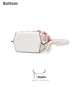 Detailed bottom view of white PU leather bucket bag with hexagonal base and silk scarf