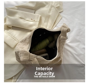 Macro detail of the spacious interior of the beige woven tote bag with daily essentials