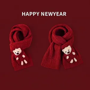 Red chunky knit scarf with cute teddy bear doll decor for winter warmth and festive style