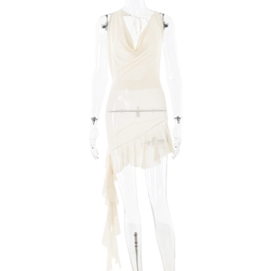 Detail of white backless dress featuring a cowl neck and ruffled asymmetric hemline