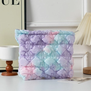 Macro shot of gradient bubble textured makeup bag with zipper closure on home vanity