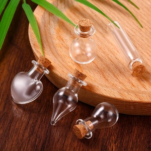 Macro view of assorted mini glass wish bottles with cork stoppers on a rustic wooden tray