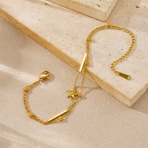 Elegant gold double-layered chain bracelet with starfish charm on minimalist stone