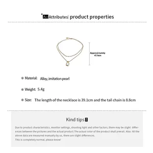 Detail view of double-layer necklace with dimensions, pearls, and gold pendant