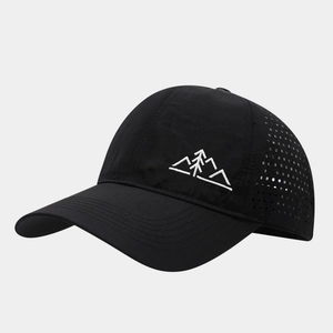 Detail showing laser-cut ventilation holes on a black quick-dry mountain baseball cap