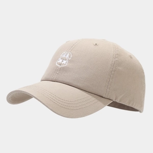 Detailed close-up of cute white rabbit embroidery on a beige cotton baseball cap