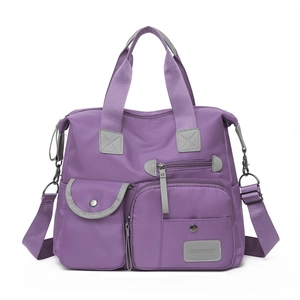 Macro shot of purple nylon fabric texture and stitching details of the shoulder bag
