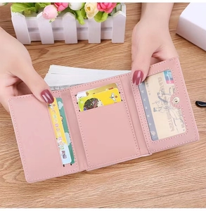 Internal view of pink tri-fold wallet showing card slots and ID window holder