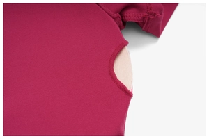 Macro detail of raspberry yoga top with side cutout design and high-quality stitching