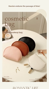 Macro shot of stylish woven texture and gold zipper details on semi-circle makeup bags