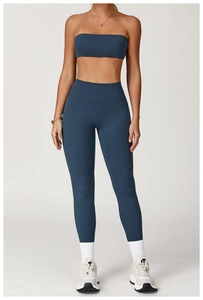 Detail view of a dark blue two-piece matte yoga set with tube top and high waist leggings