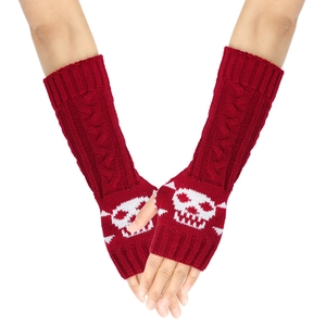 Detail of red knitted arm warmers with white skull pattern and cable knit texture