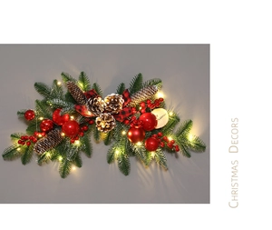 Detail of Christmas wreath with pine cones, red berries, LED lights and Merry Christmas sign