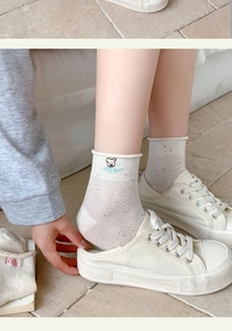 Detail of off-white mesh socks with bear embroidery and NICE DAY text in white shoes